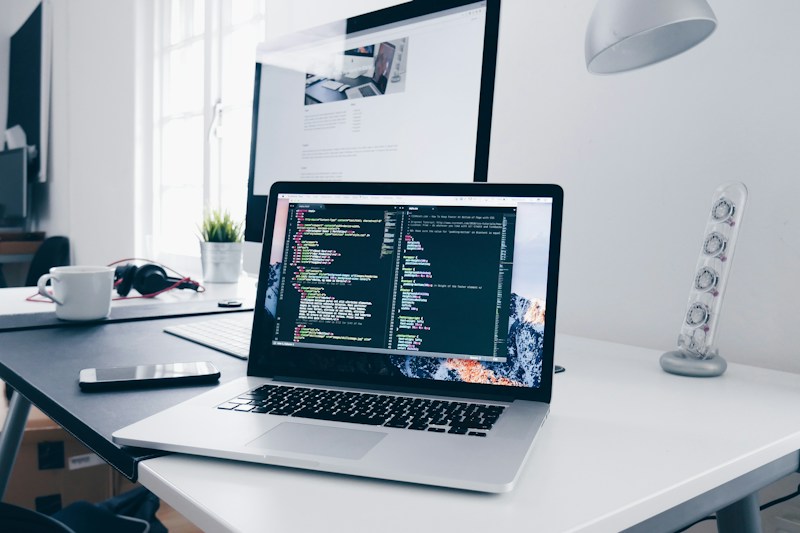 A laptop and development workspace used to improve front-end code and site performance
